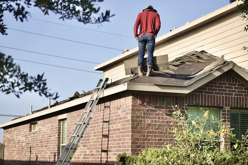Professional roofer working on a residential roof in Southfork